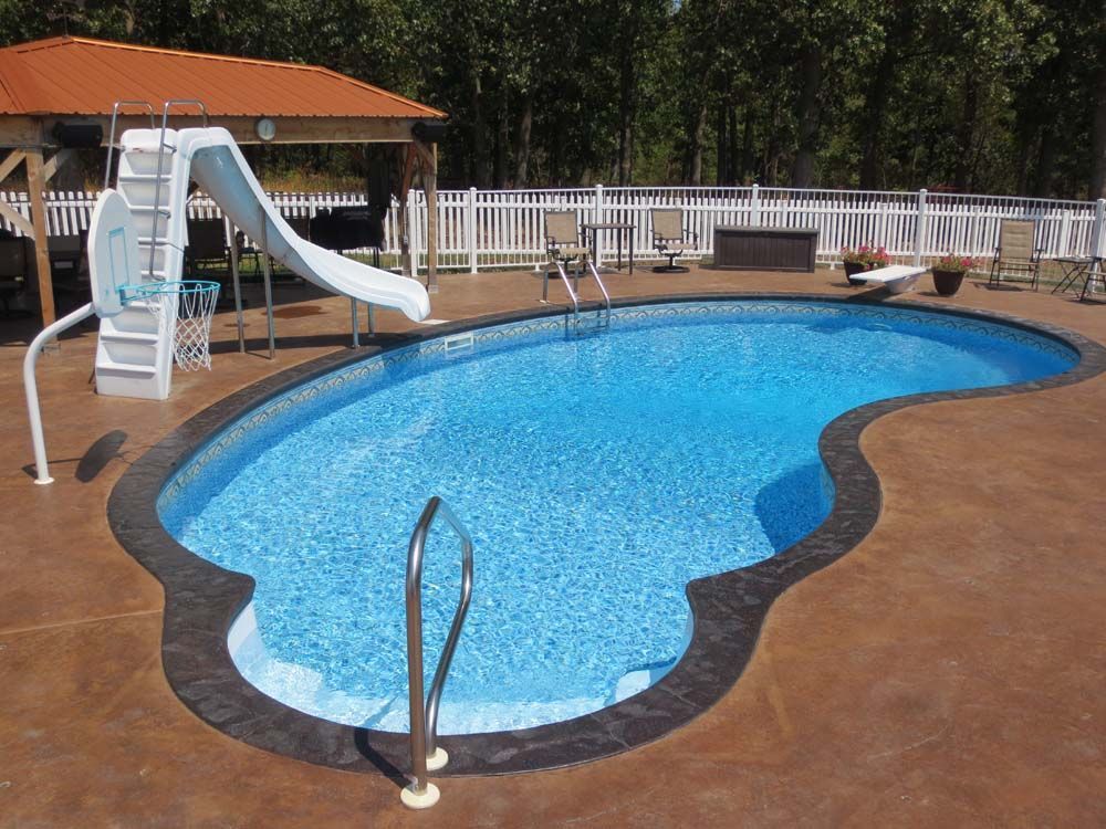 A large swimming pool with a slide and stairs