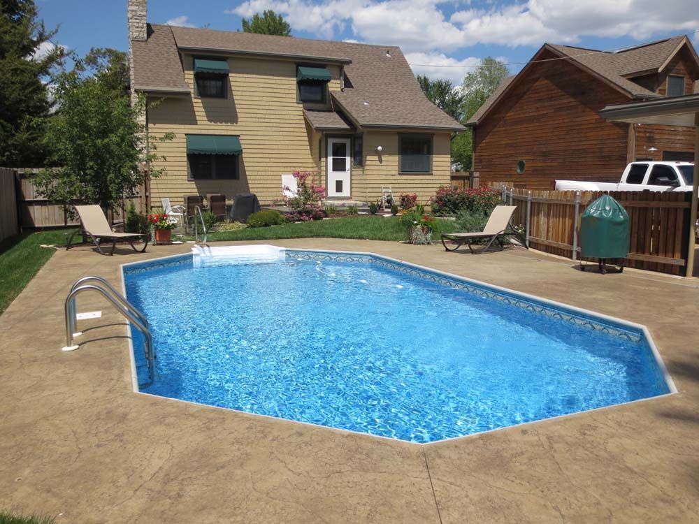 A large swimming pool in the backyard of a house