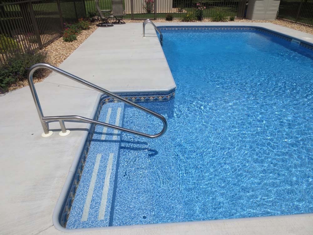 A large swimming pool with stairs leading to it