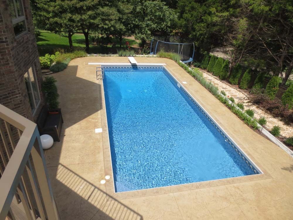 An aerial view of a large swimming pool surrounded by trees