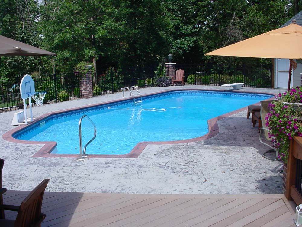 A large swimming pool surrounded by umbrellas and chairs
