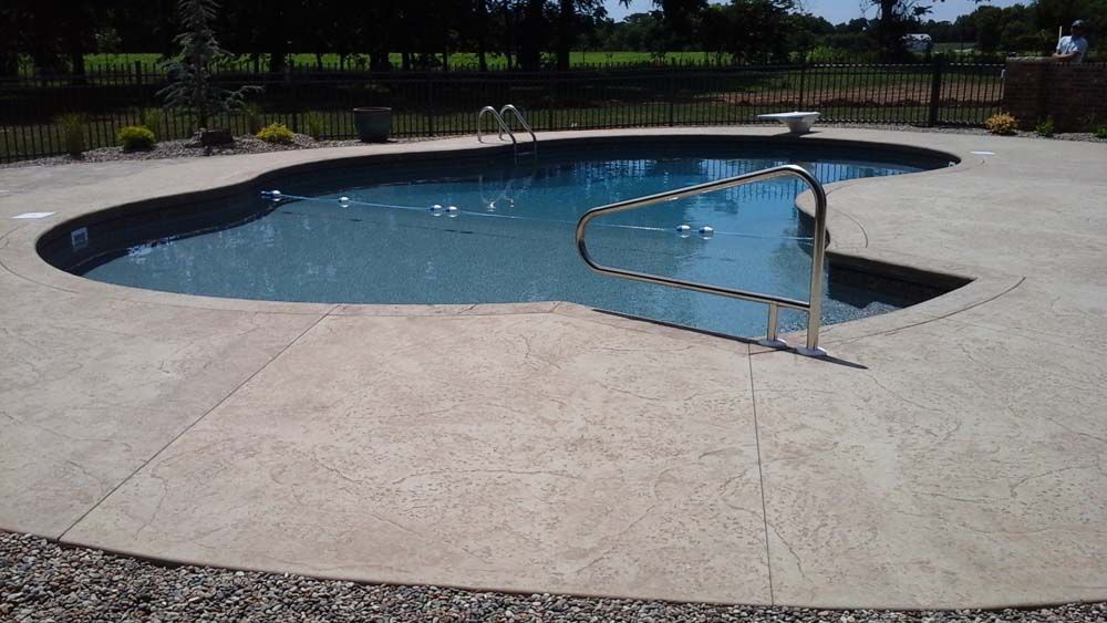 A large swimming pool with stairs leading to it