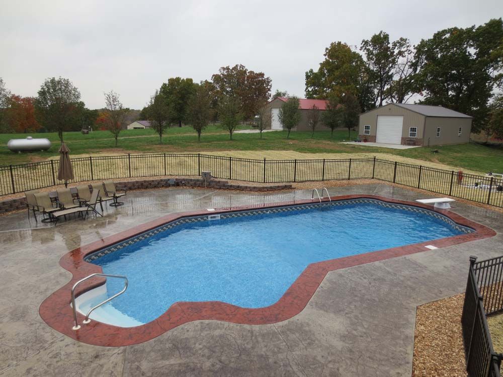 A large swimming pool with a fence around it