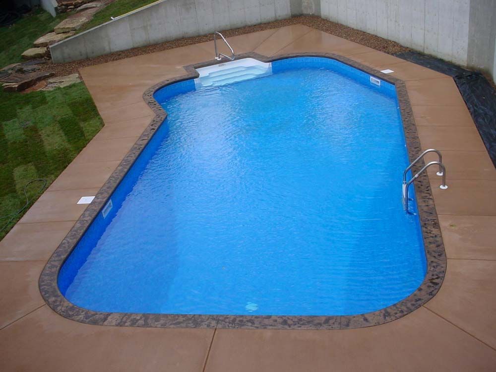 An aerial view of a swimming pool in a backyard