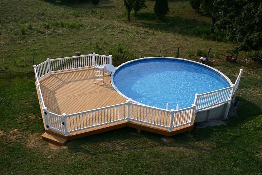 An aerial view of a swimming pool with a wooden deck surrounding it.