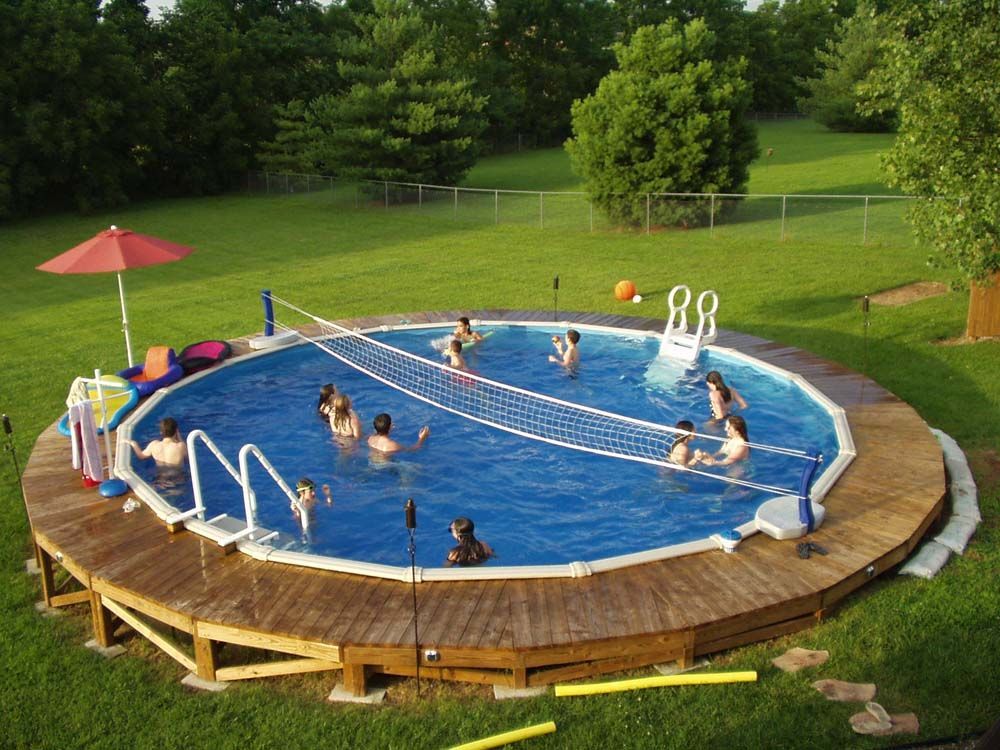 A group of people are playing volleyball in a swimming pool