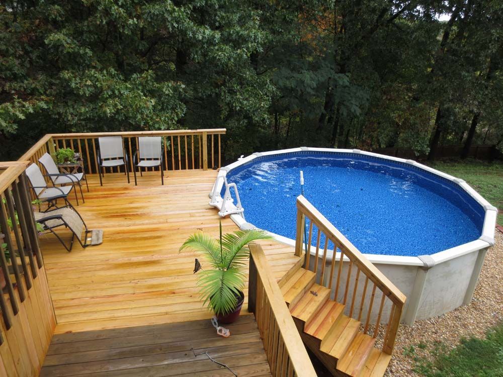 A wooden deck with stairs leading to a swimming pool