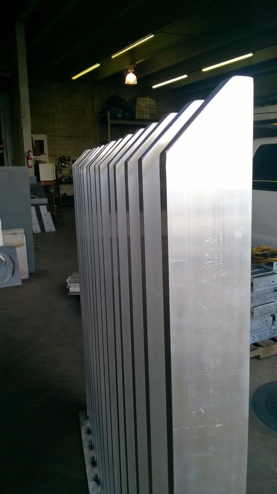 Stacked metal sheets standing upright in an industrial workshop