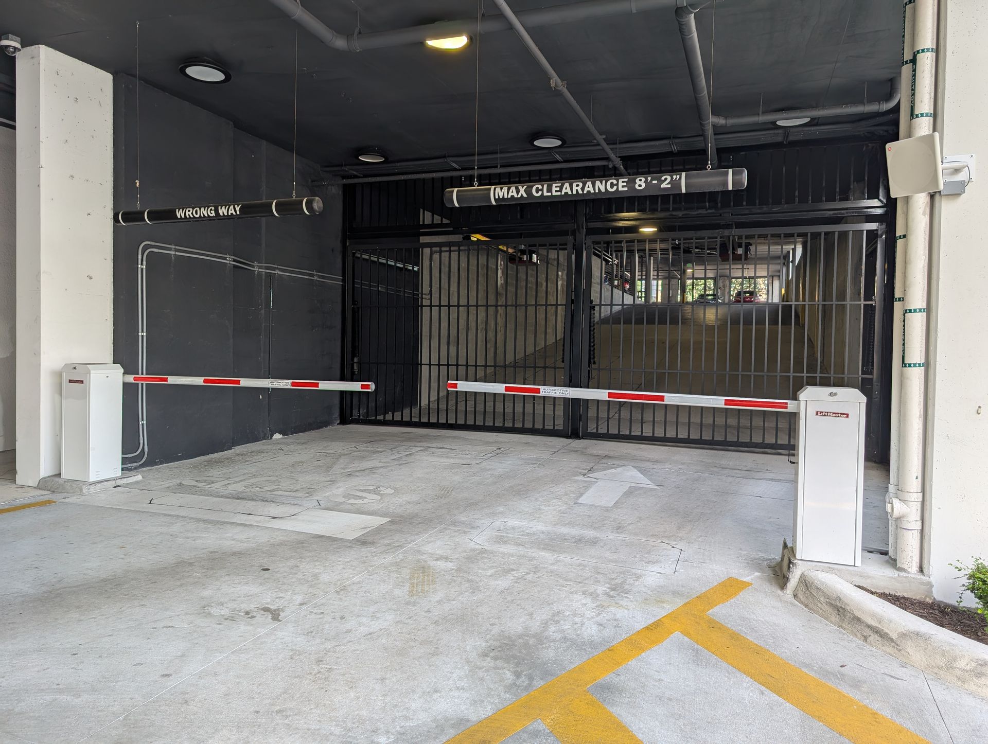 Parking garage entrance with closed gate and red-and-white barrier arm