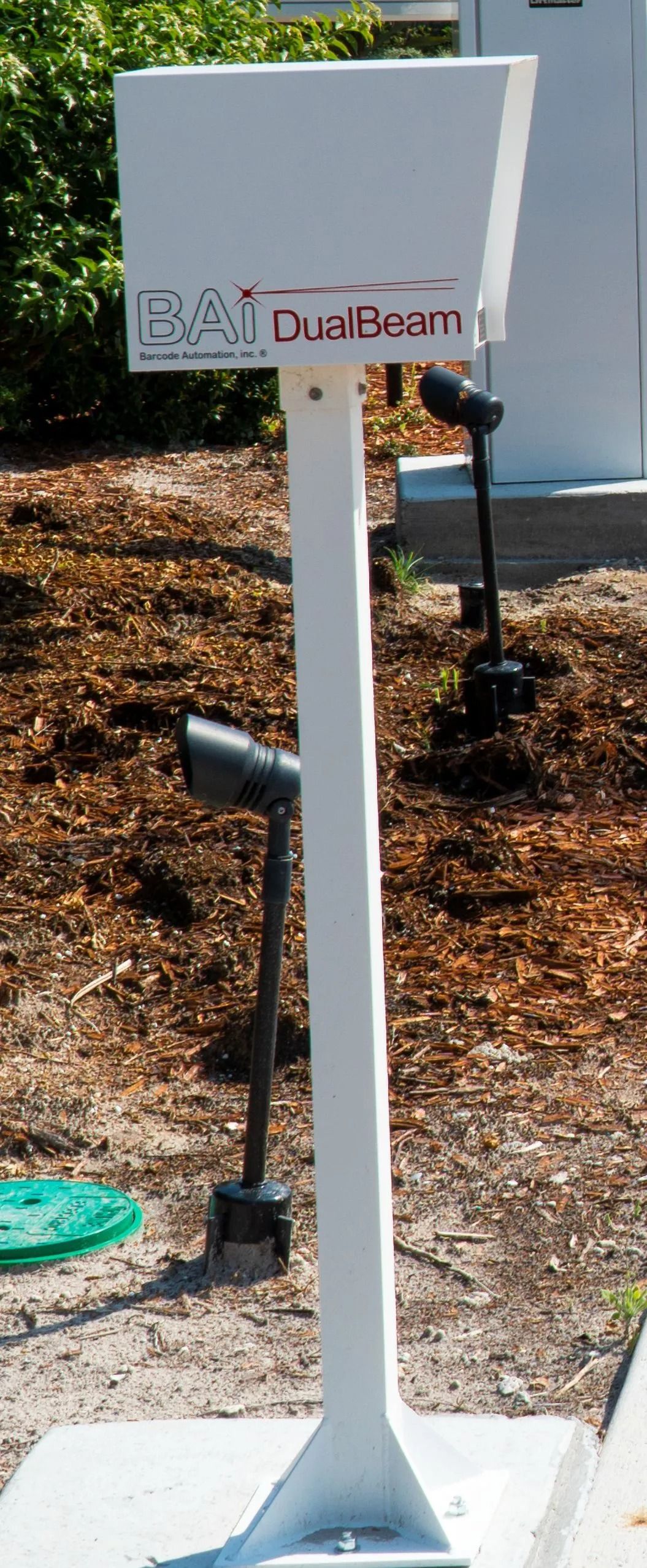 White utility box on a metal post in a landscaped outdoor area, labeled “Duke Energy.”