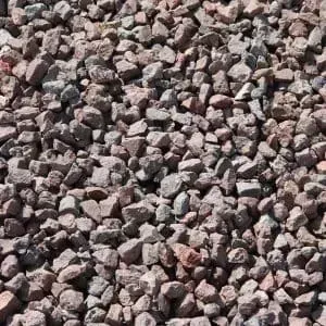 Crushed gravel in shades of red, gray, and brown, filling the frame.