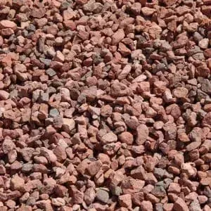 Red crushed gravel, small pieces, filling the frame.