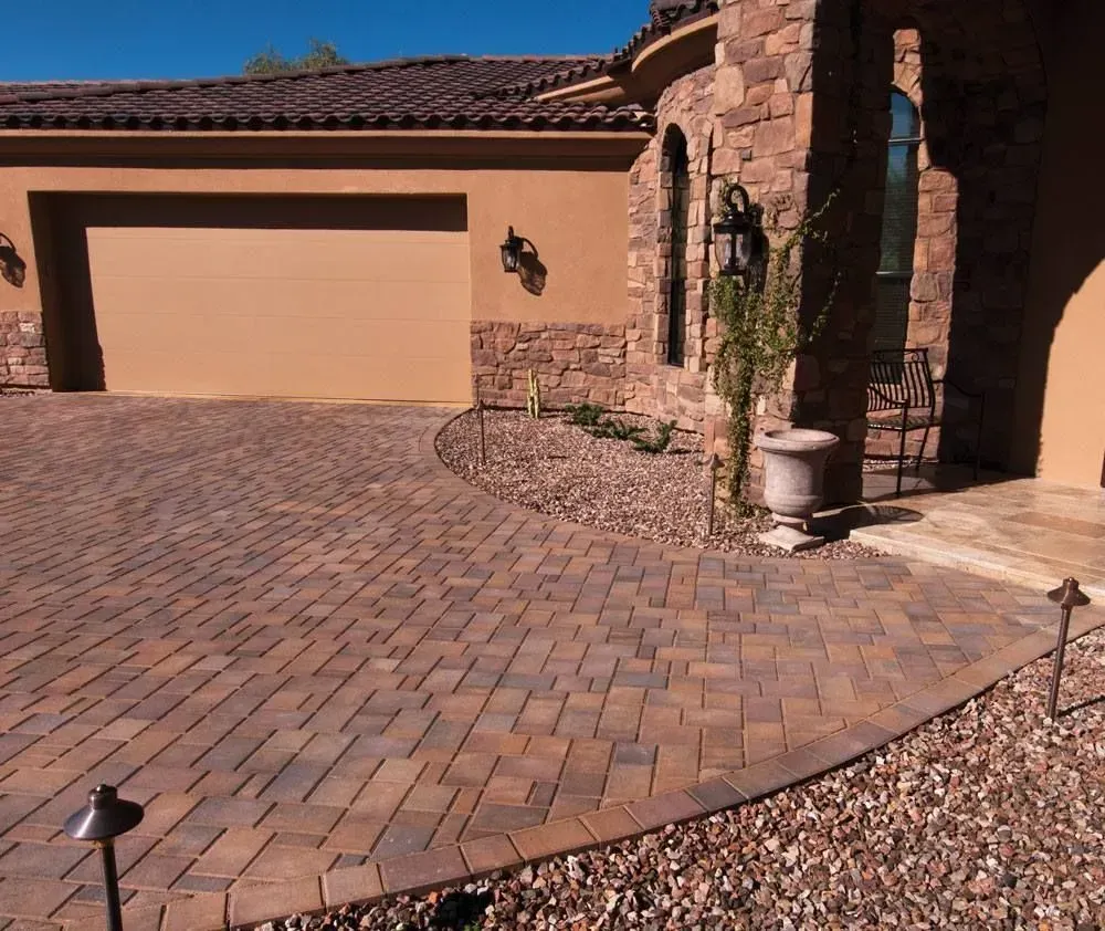 Brick patio with stacked pavers for sale in a yard.
