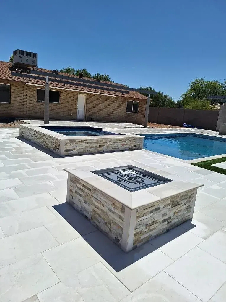 Outdoor patio with a pool, spa, and fire pit.