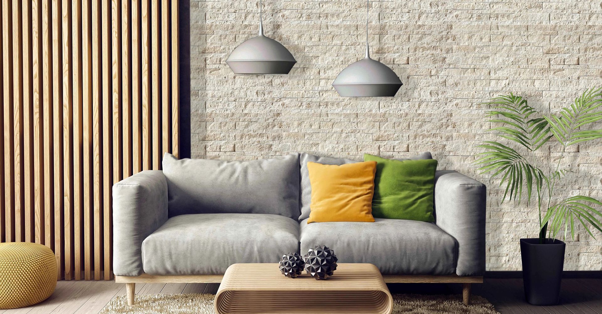 Modern living room with gray couch, stone wall, wooden panel, and pendant lights.