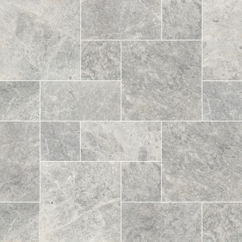 Gray stone tile flooring with various rectangular and square shapes, with white grout lines.