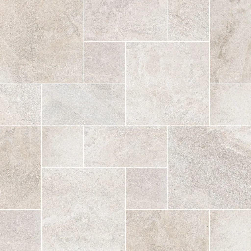 Light beige stone tile pattern. Rectangular and square tiles with visible grout lines.