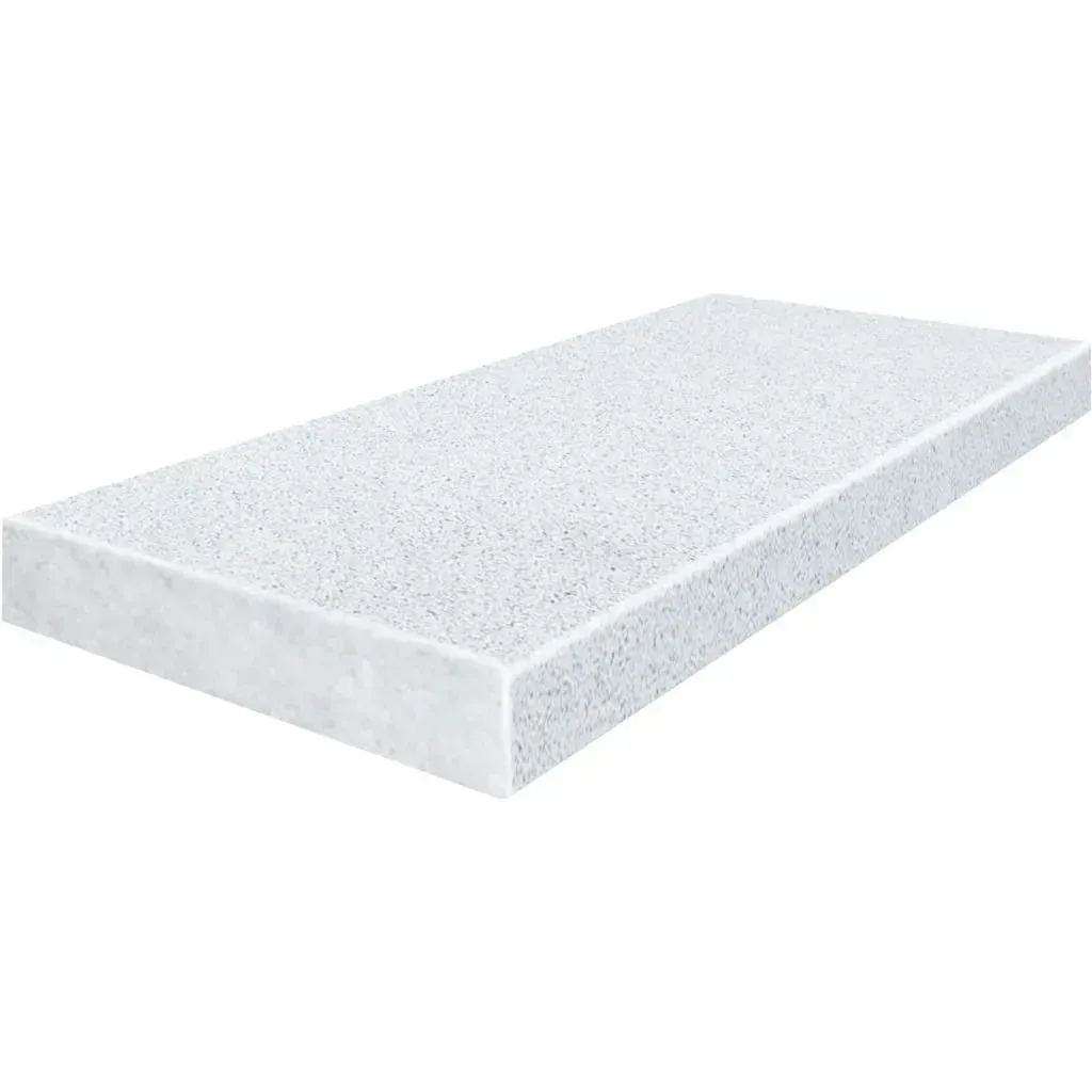 White speckled countertop with a beveled edge.