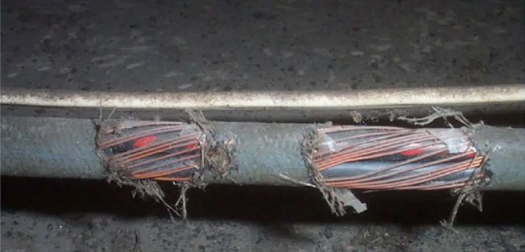 A close up of a broken wire on a pipe