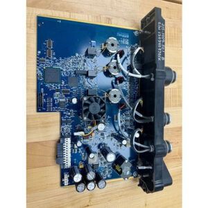 Blue circuit board with attached black component; fan, wires, and electronic components visible.