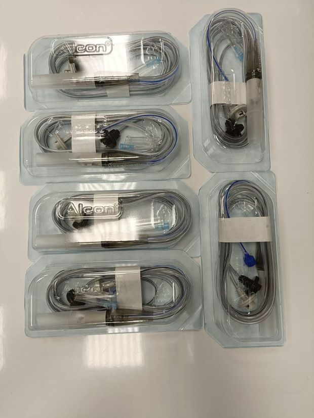 Six packaged medical cables in clear plastic, white labels, coiled cords.