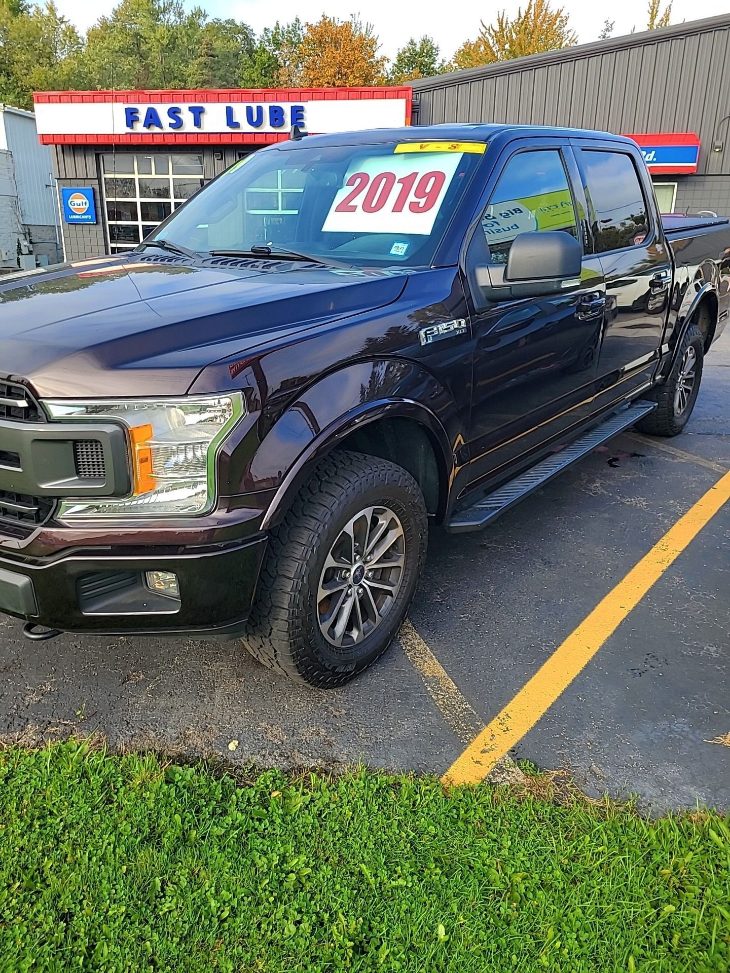 Dark brown 2019 Ford F-150 truck parked in a lot, with