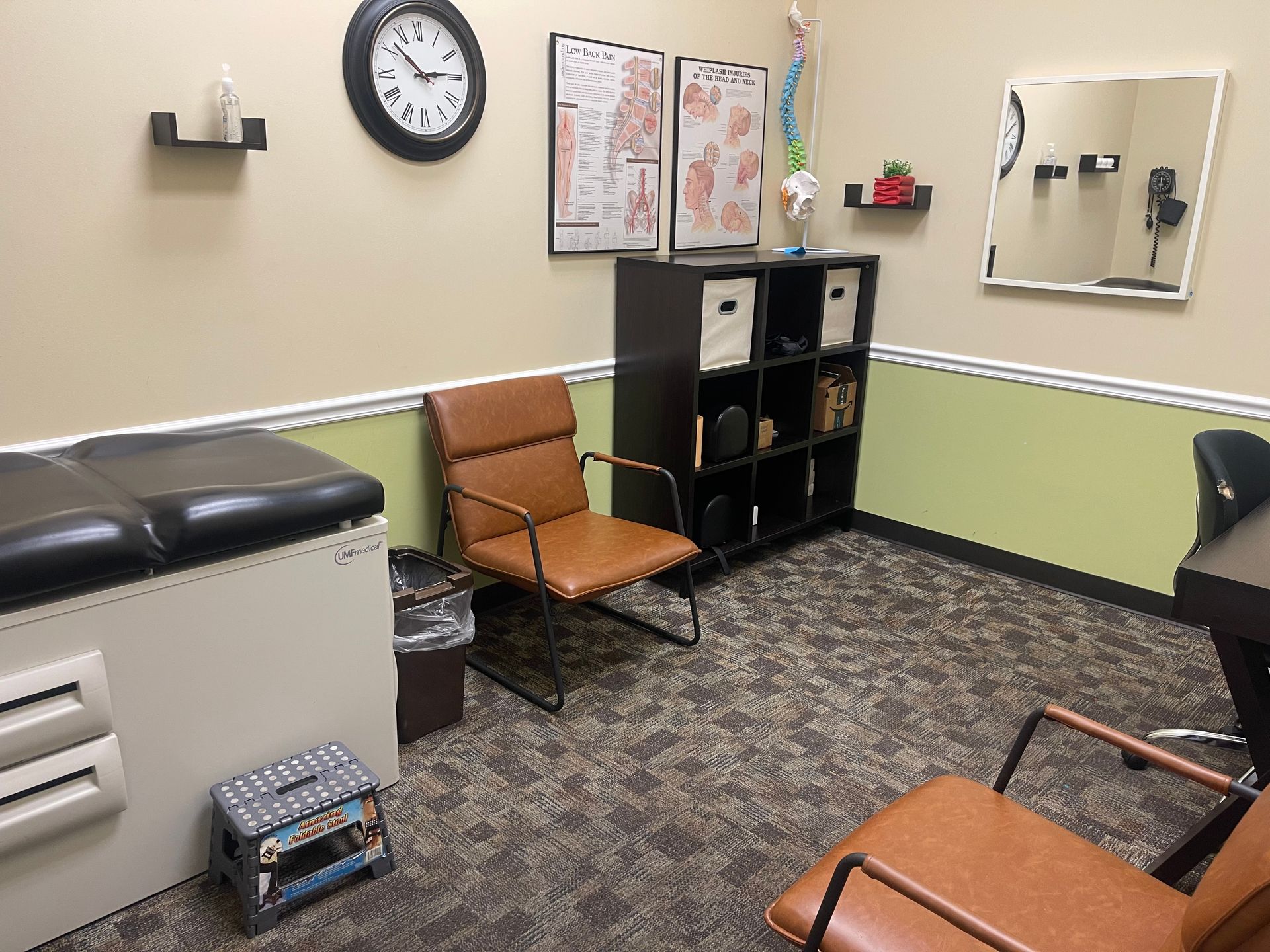 There is a clock on the wall above the chair in the room.