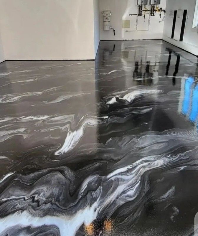 Glossy black-and-white marbled floor in a modern hallway with a bright blue reflection on the right