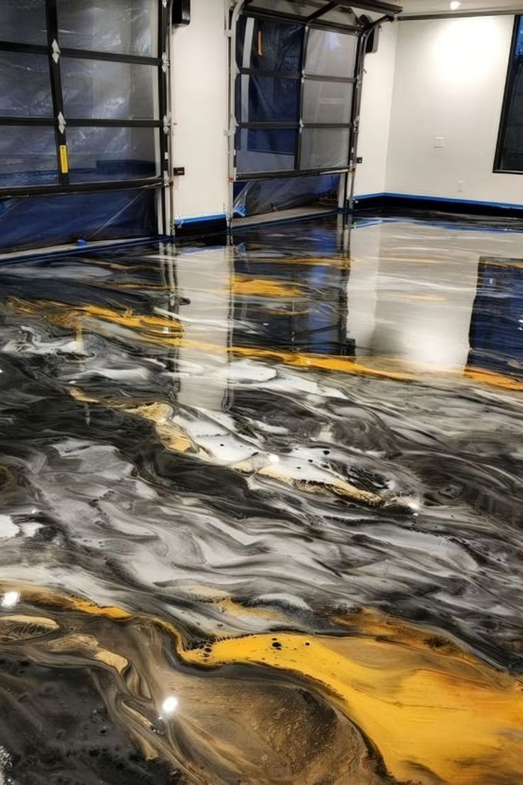 Polished black, white, and gold marble floor in an empty room with blue-covered windows and reflected lights