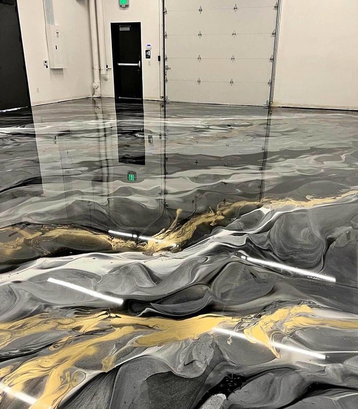 Flooded room with rippling water over gray tarp and a black door in the background