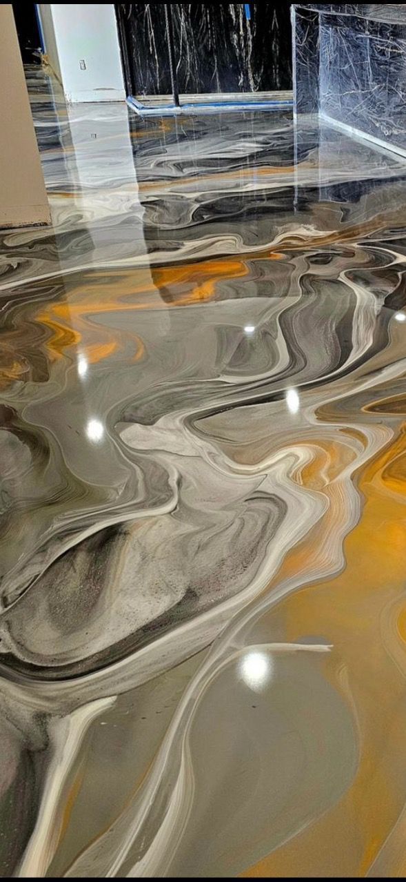 Swirling gray, white, and amber marbled floor or countertop with glossy reflections