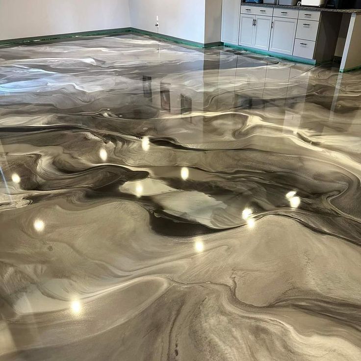 Shiny marbled floor with swirling gray, black, and beige patterns in a room with cabinets along one wall