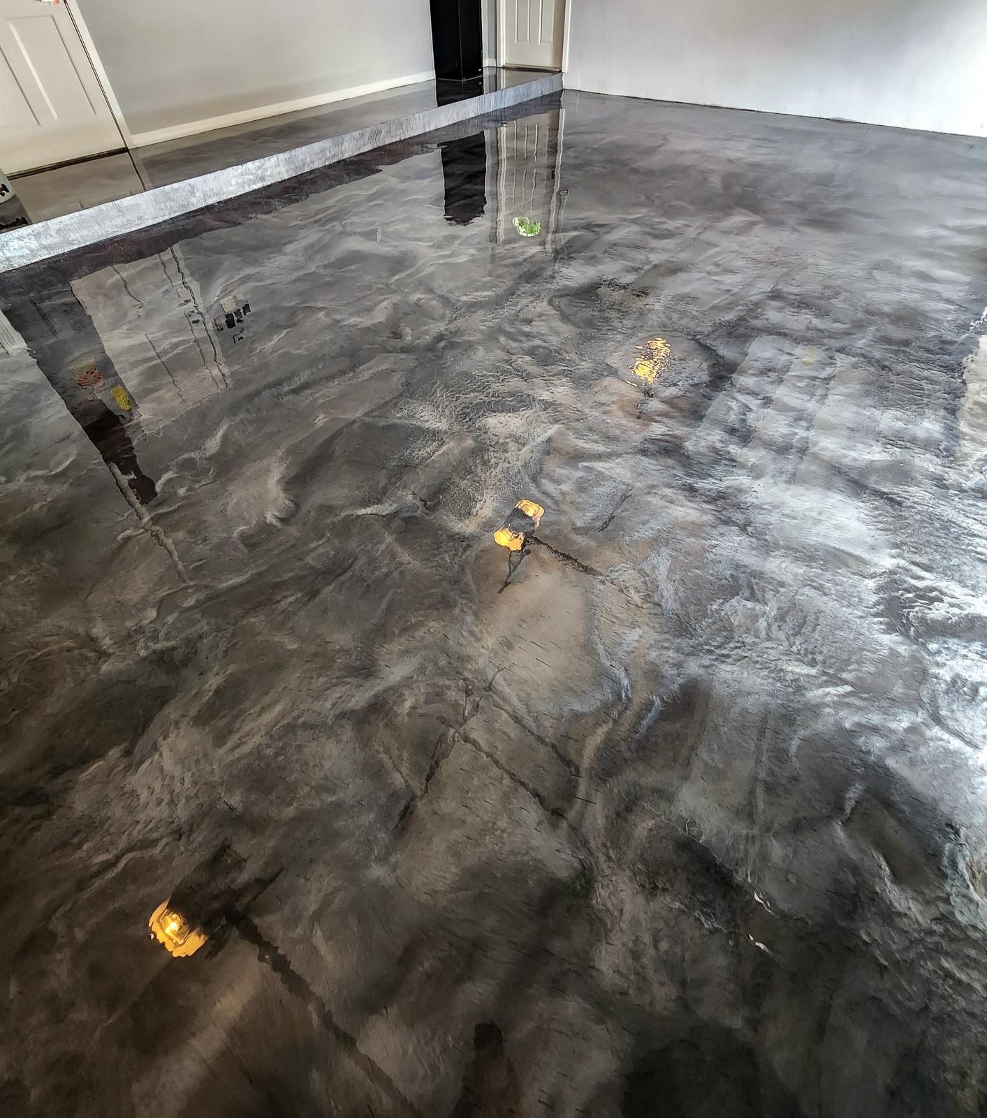 Glossy gray marble floor in a bright indoor room with reflections of lights and columns