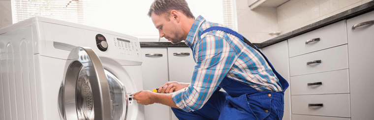 Man repairing a washing machine