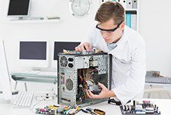 Man fixing computer tower