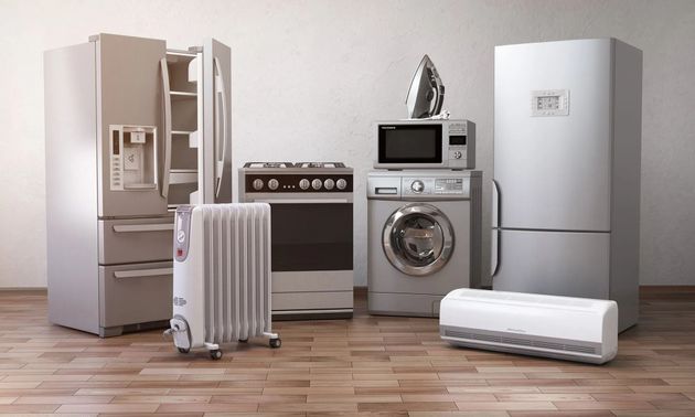 Kitchen appliance set in a bright room: fridge, stove, microwave, washer, radiator, and air conditioner.