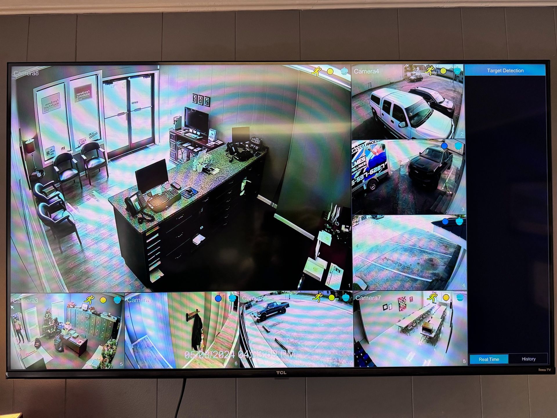 A large flat screen tv is hanging on a wall.