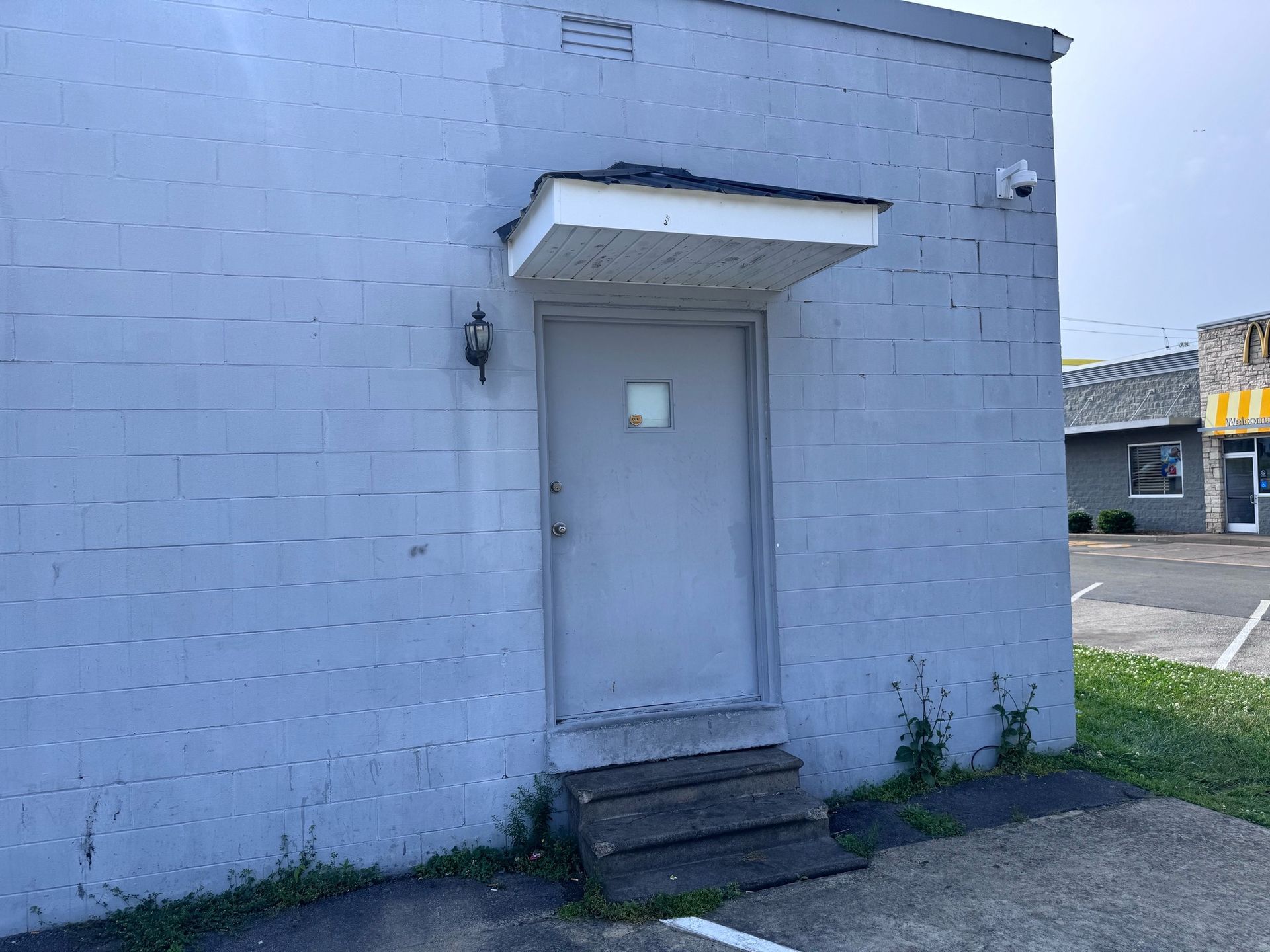 There is a door on the side of a building with stairs leading up to it.