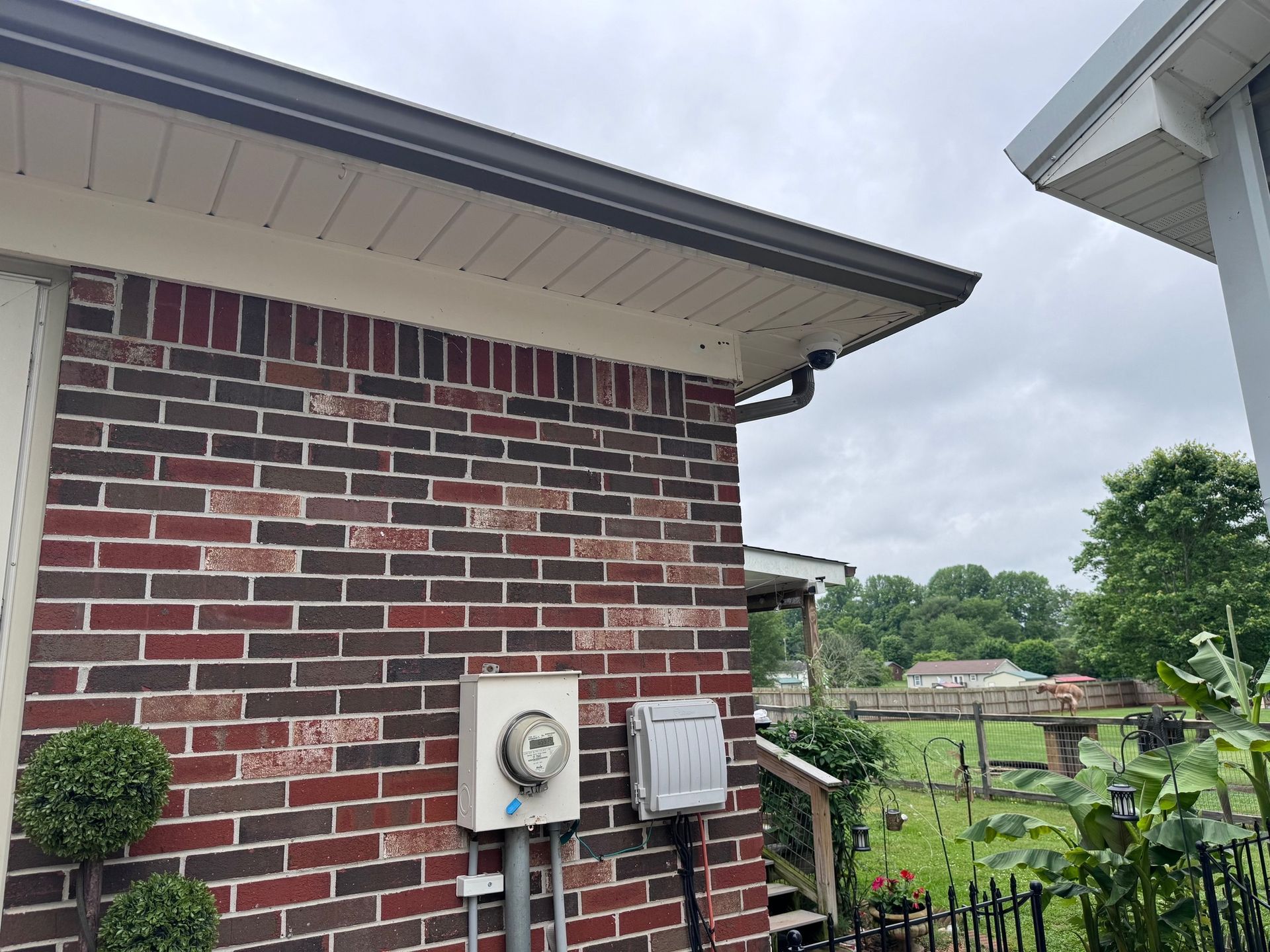 A brick house with a mailbox on the side of it