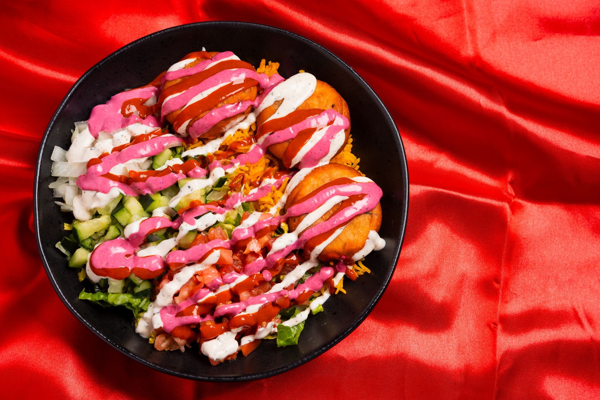 Two aluminum pans filled with vegetables and sauce on a table.