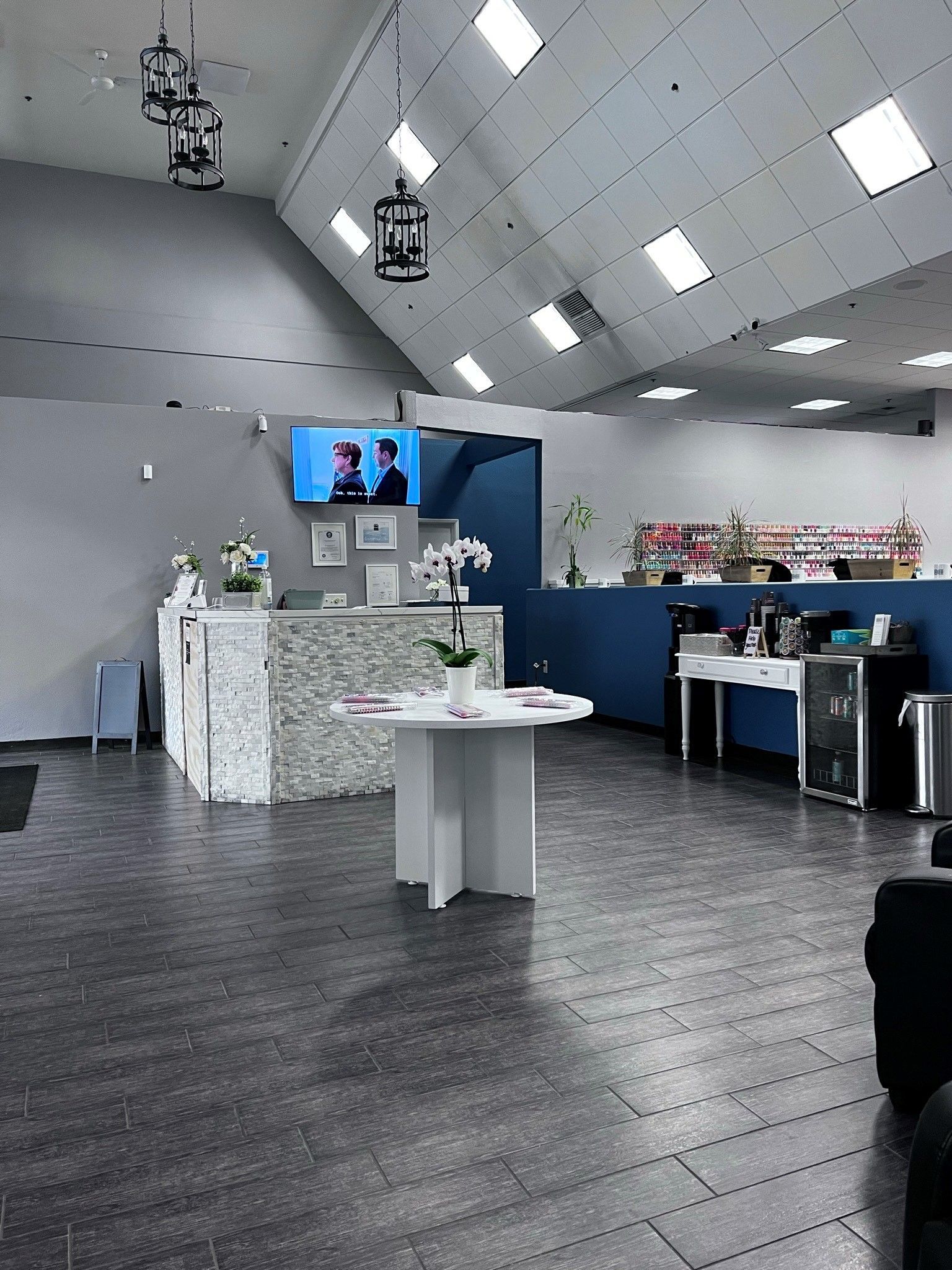 the inside of a nail salon with a tv on the wall