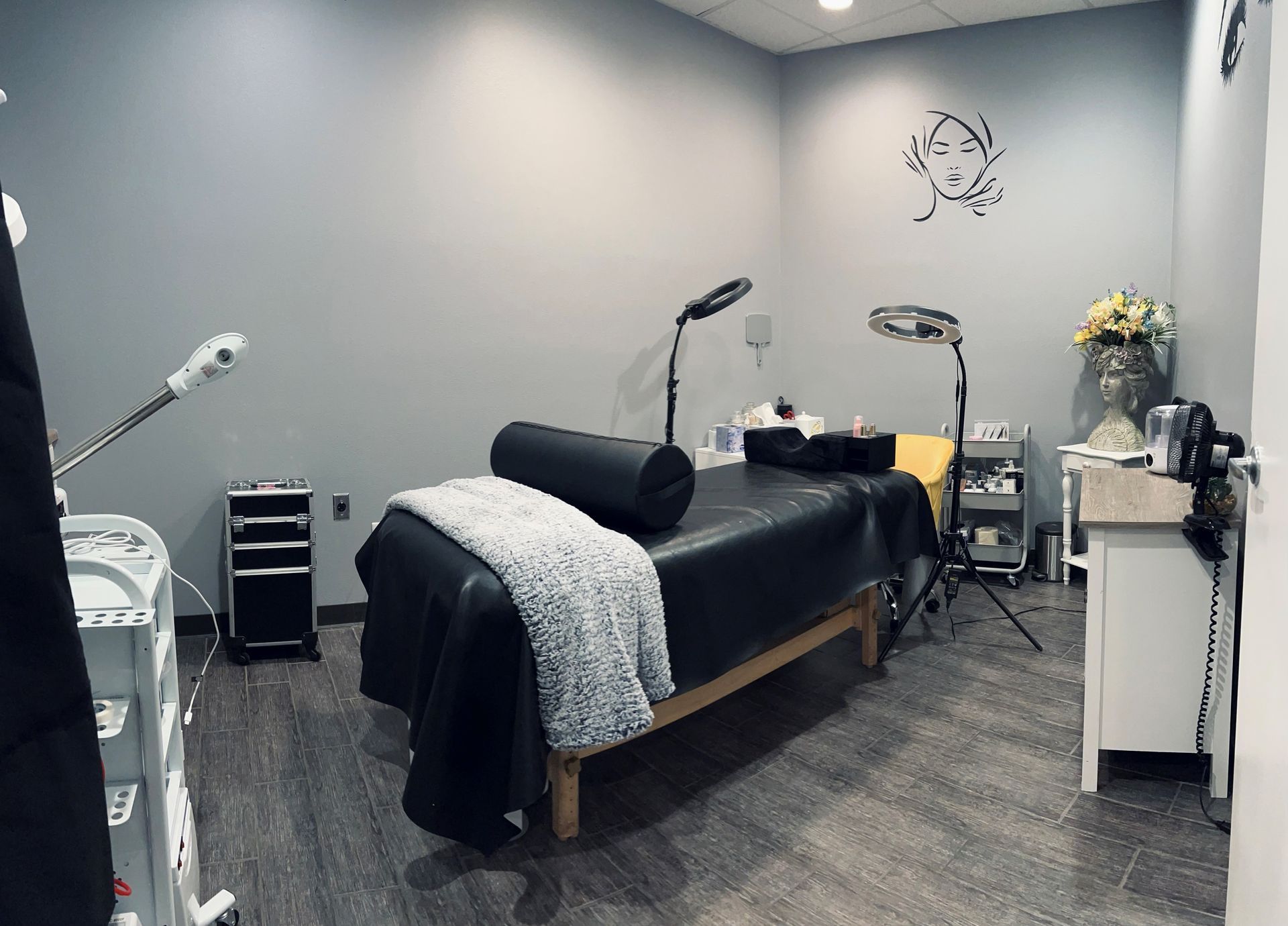 a room with a bed and a drawing of a face on the wall
