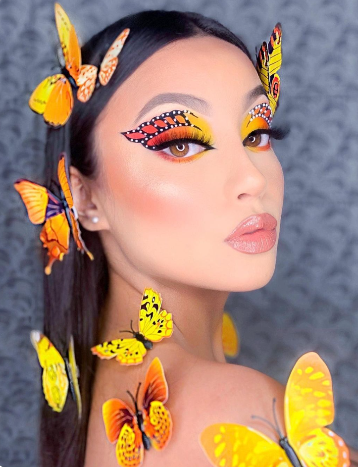 a woman with butterflies painted on her face and hair