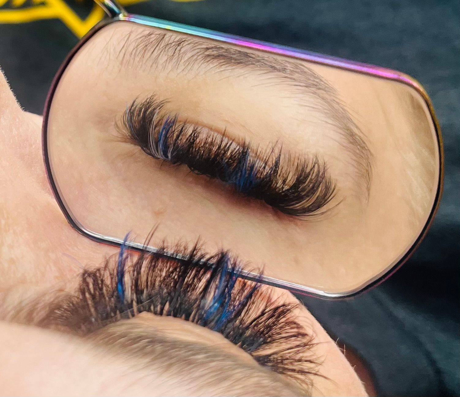 a close up of a woman 's eye in a mirror