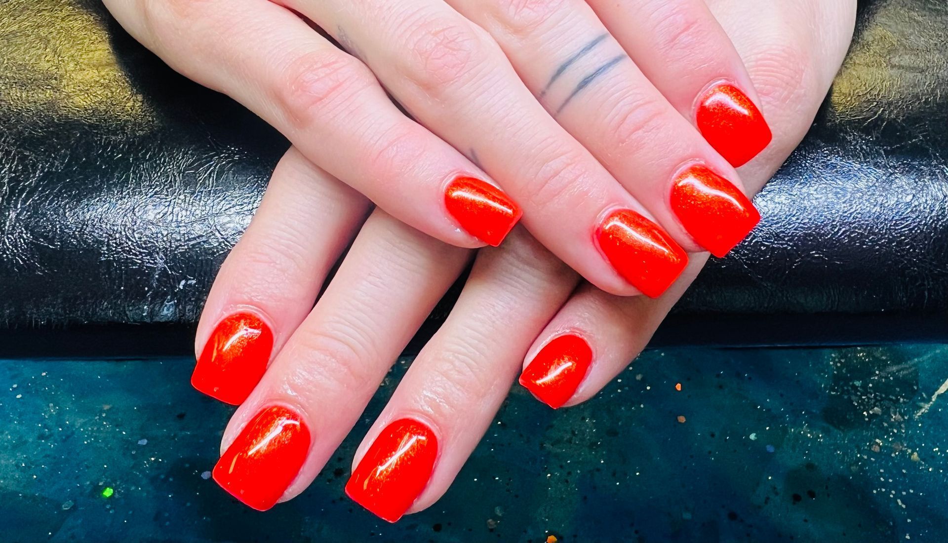 a close up of a woman 's hands with red nails