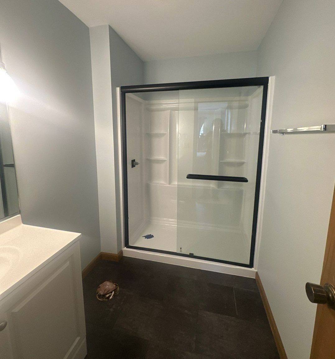 A bathroom with a walk-in shower and a sink.