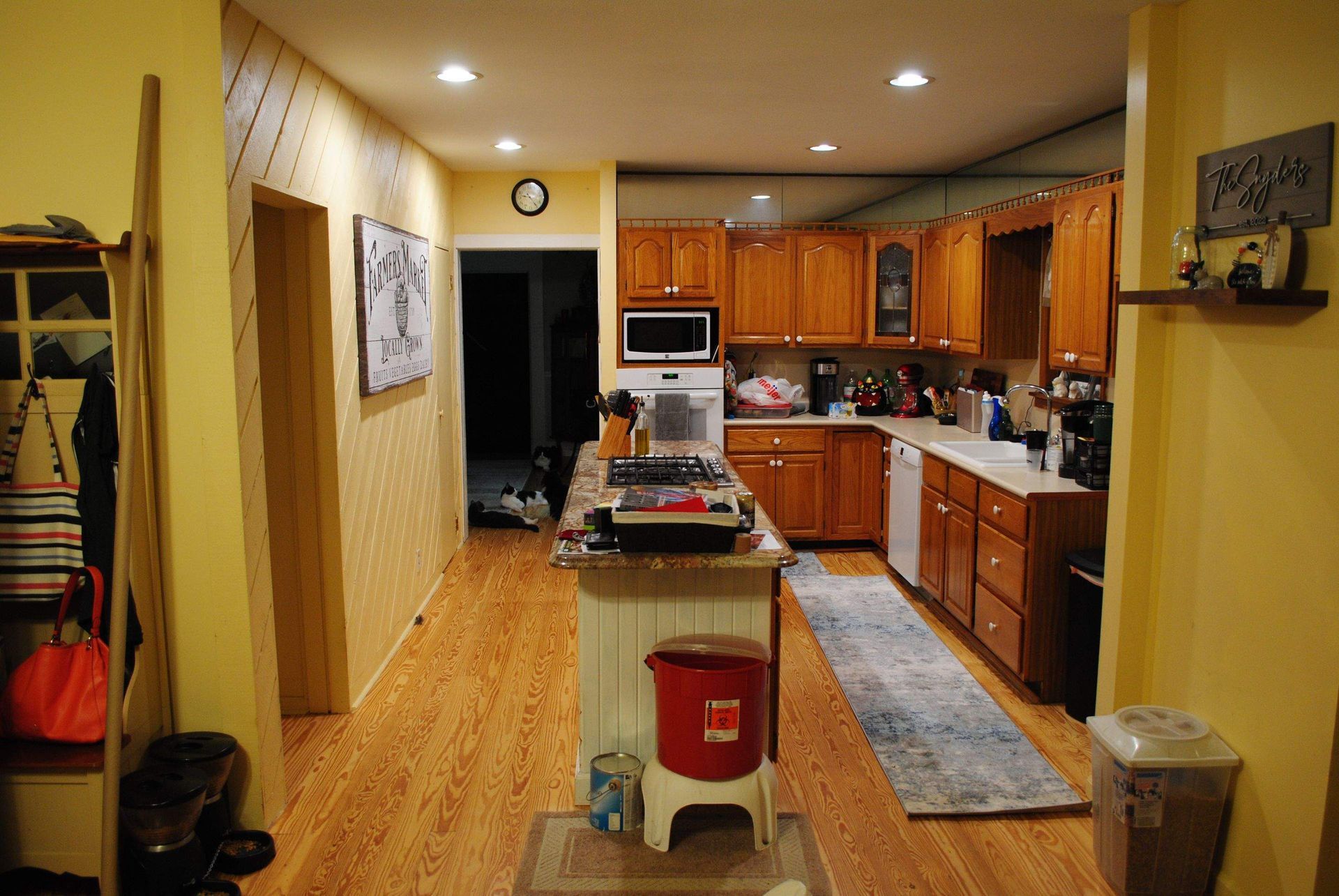 A kitchen with a sign on the wall that says no dogs allowed.