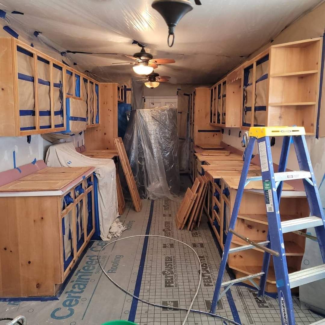 A kitchen under construction with a ladder in the middle