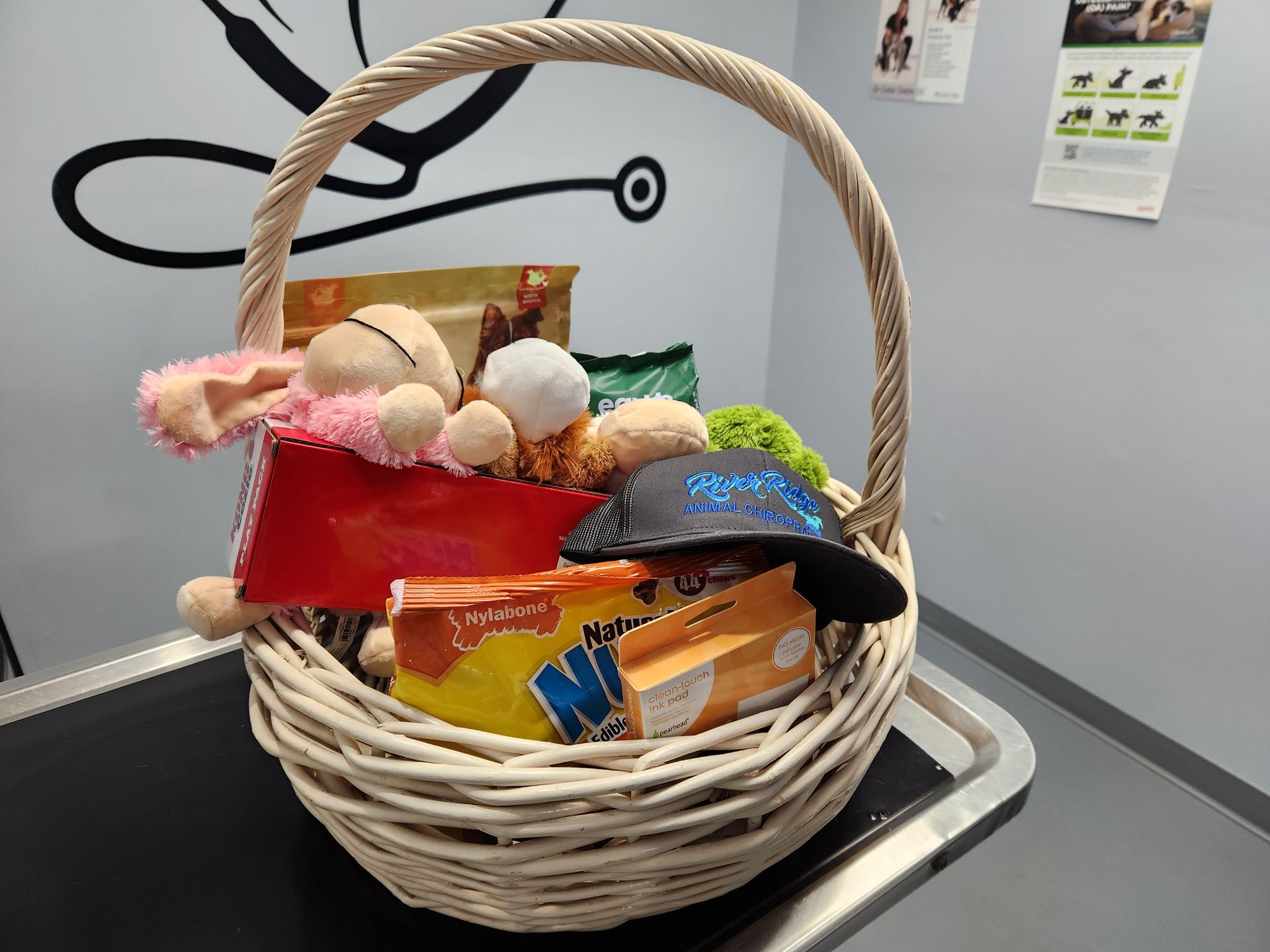 A basket filled with toys and snacks is sitting on a table.
