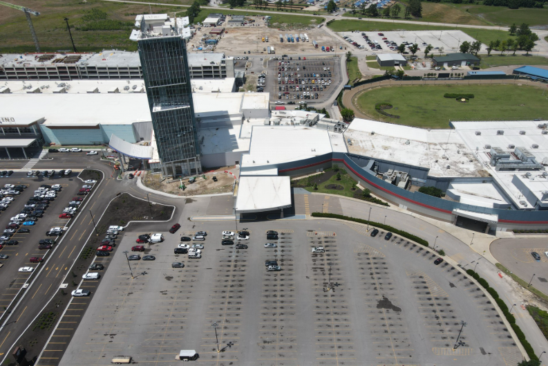 An aerial view of a large building with a parking lot in front of it